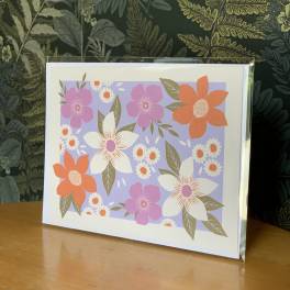 Floral greeting card with pink, orange, and white flowers on a lavender background