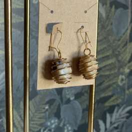 Pair of wire-wrapped stone drop earrings on a display card