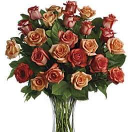 Bouquet of red and peach roses in a clear glass vase