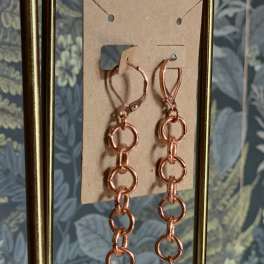 Pair of dangling earrings with copper chain links and white stone drops
