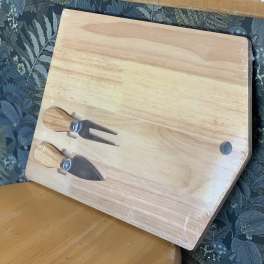 Wooden cutting board with a fork and knife attached