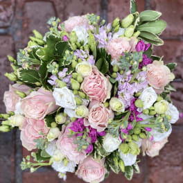 Round bouquet of pink and white roses with lavender flowers