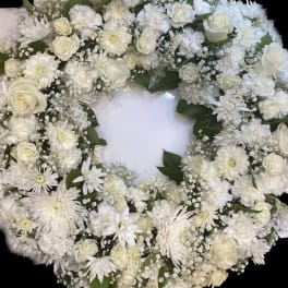 White floral wreath with roses and daisies