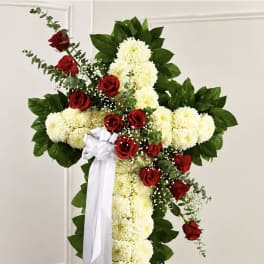 Cross-shaped floral spray with red roses and white chrysanthemums