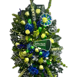 Large standing floral spray with yellow roses and blue flowers