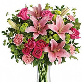 Pink lilies and roses in a clear glass vase