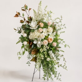 Tall white and blush floral standing arrangement on a metal easel