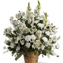White floral arrangement in a woven basket