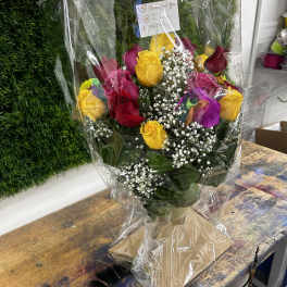 Bouquet of multicolored roses wrapped in clear plastic