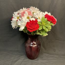 Red roses and white daisies in a burgundy vase