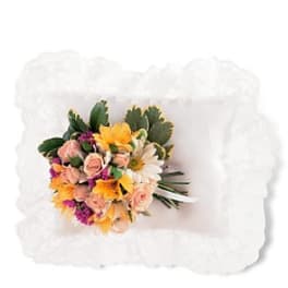 Bouquet of mixed flowers on a white pillow