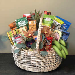 Gift basket with snacks, bananas, and a few orchids