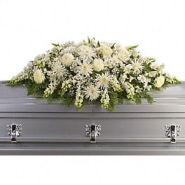 White floral casket spray with chrysanthemums and greenery