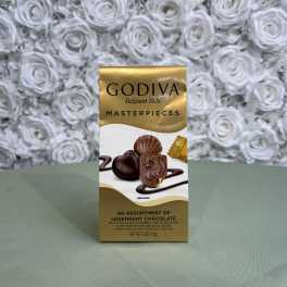 A box of Godiva assorted chocolates on a table.