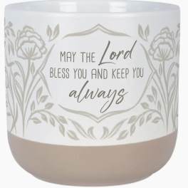 White candle jar with floral pattern and blessing text