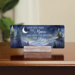 Memorial card with moon and stars on a wooden stand