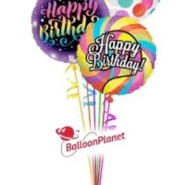 Cluster of colorful birthday balloons with printed messages.