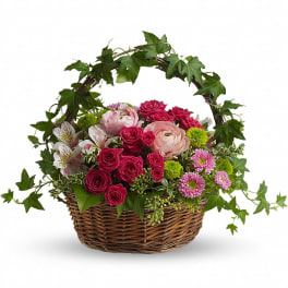 Basket of pink and red roses with daisies and ivy