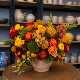 Colorful mixed flower arrangement in a ceramic vase