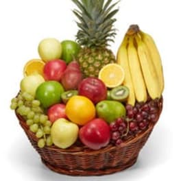 Fruit basket with pineapple, bananas, apples, grapes, and citrus