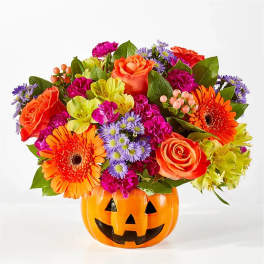 Mixed bouquet in a jack-o'-lantern pumpkin container