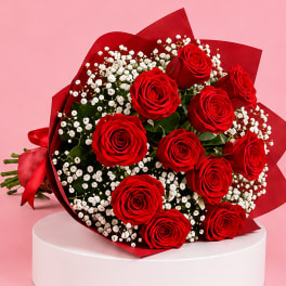 Bouquet of red roses with white baby's breath in red wrap