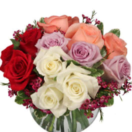 Bouquet of red, peach, lavender, and white roses in a vase