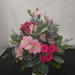 Pink roses and alstroemeria in a clear glass vase