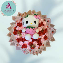 Hello Kitty plush surrounded by red and pink roses with strawberry wrapping