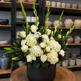 White floral arrangement in a black textured vase