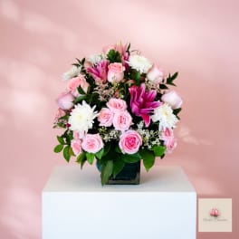 Pink and white rose bouquet with white chrysanthemums in a square vase