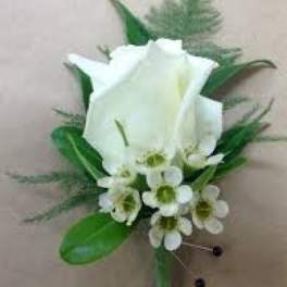 White calla lily boutonniere with small white accent flowers