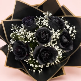 Bouquet of black roses with white baby's breath in black and gold wrap