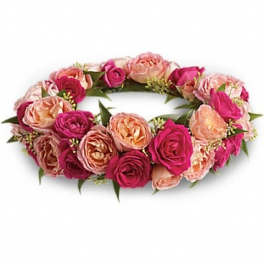 Pink and peach rose floral wreath on a white background