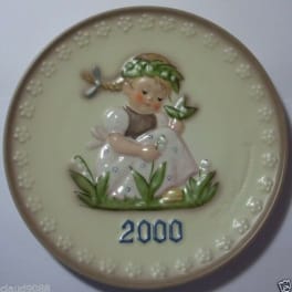 Decorative plate with a girl relief and the year 2000