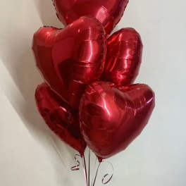 Cluster of red heart-shaped balloons tied together