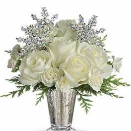 White roses and silver accents in a metallic vase