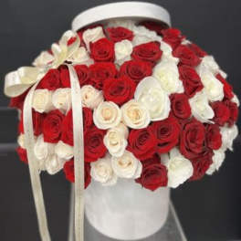 Red and white rose bouquet in a white hat box with ribbon
