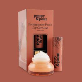 Lip care duo in coral packaging with a scrub jar and balm tube