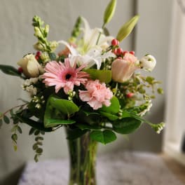 Pink and white mixed bouquet in a clear glass vase