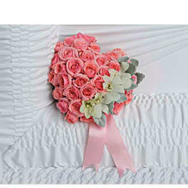 Pink rose bouquet with pale flowers and a pink ribbon on white fabric