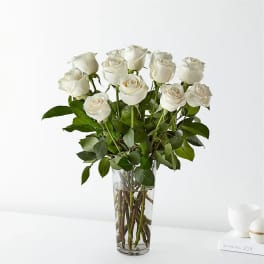 White roses arranged in a clear glass vase