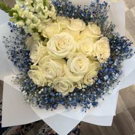 Bouquet of cream roses with blue baby's breath and white snapdragons