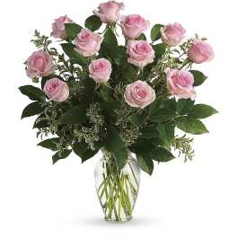 Pink roses arranged in a clear glass vase