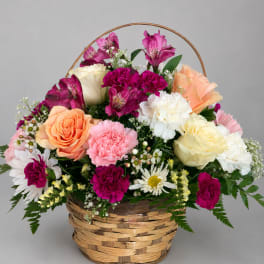 Basket arrangement of roses, carnations, daisies, and alstroemeria
