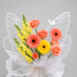 Butterfly-shaped bouquet with coral roses, gerbera daisies, and yellow snapdragons