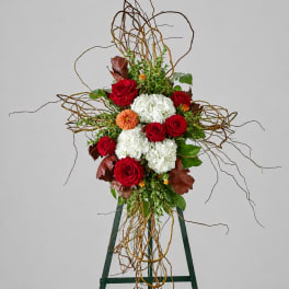 Tall floral arrangement with red roses and white hydrangeas on an easel