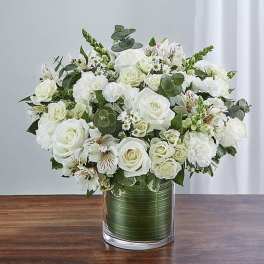 White rose bouquet in a clear glass vase