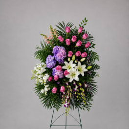 Standing floral spray with pink roses, white lilies, and purple hydrangeas