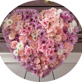 Heart-shaped floral arrangement with pink and lavender flowers